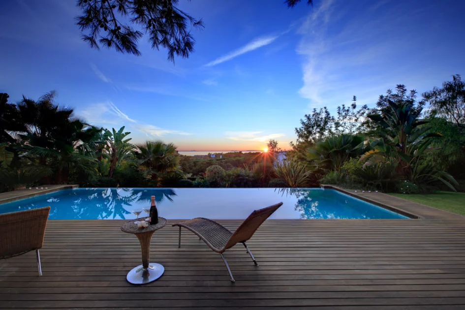 Villa terrace with infinity pool at sunset in Las Chapas, Marbella