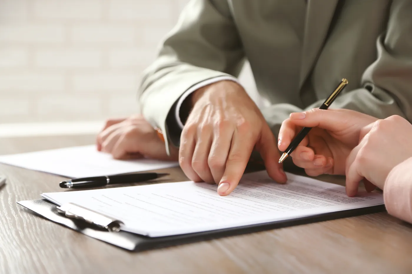 Buyer and lawyer reviewing a property purchase contract before signing at the notary in Marbella